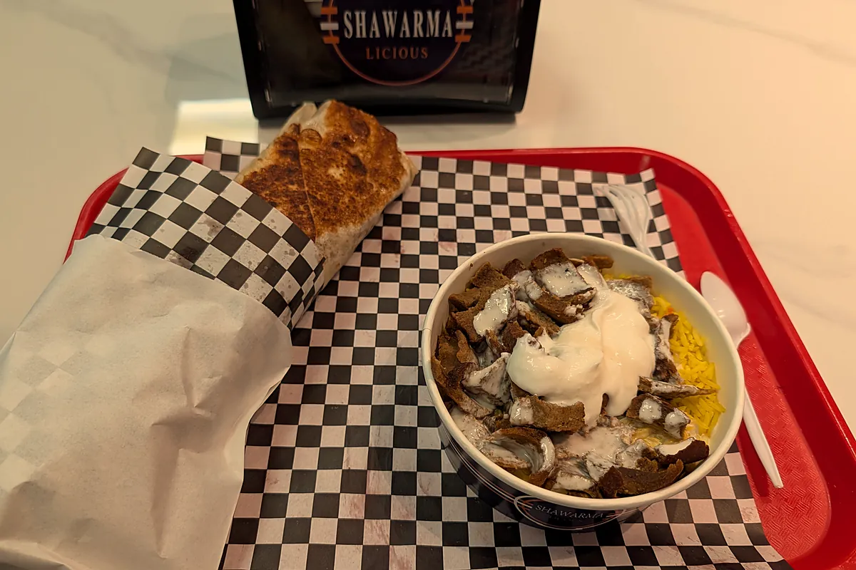 Donair rice bowl and a wrap on a red tray, with the Shawarmalicious napkin holder